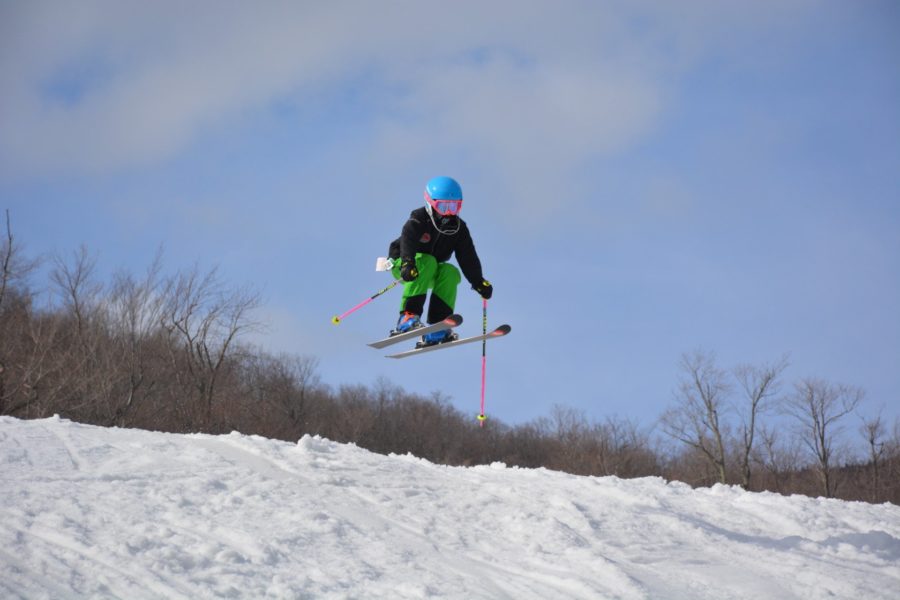 Chloe Avery of Smuggler's Notch Ski Racing Club in her Arctica Side Zip 2.0 pants jumping higher than the boys!